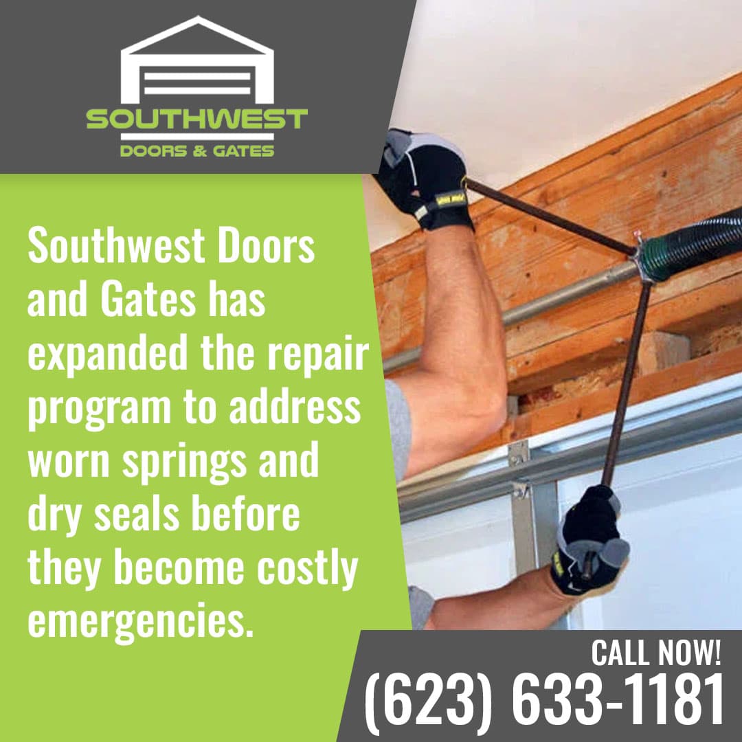 Technician adjusting garage door torsion spring using tools in residential garage