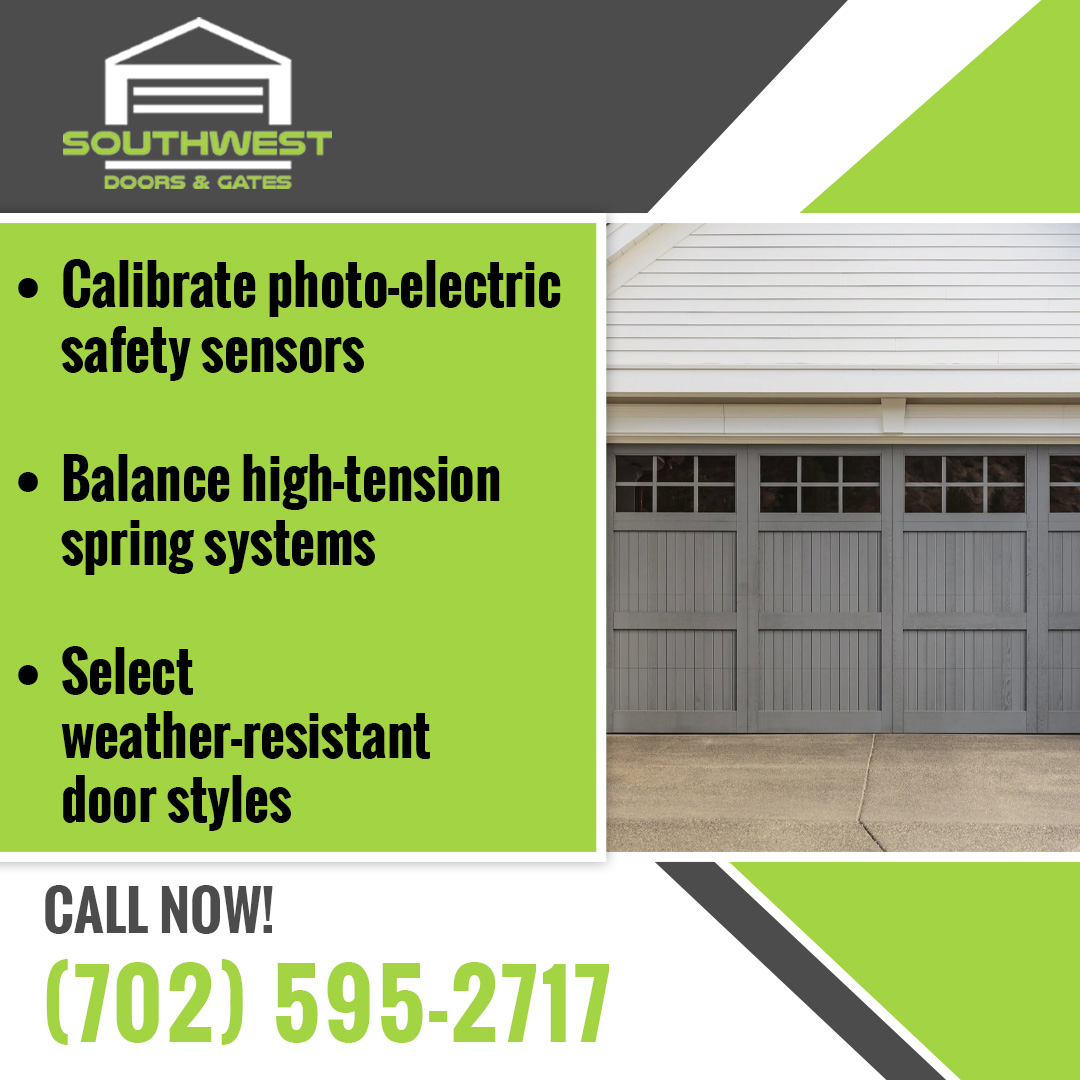 Modern gray carriage-house style garage door with top window panels on a residential driveway.