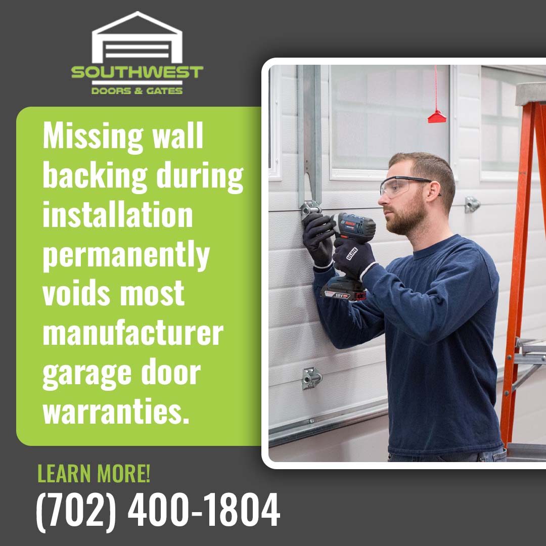Garage door technician wearing safety glasses fastening vertical track hardware with an impact driver.
